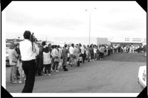 A large group of people standing in line.